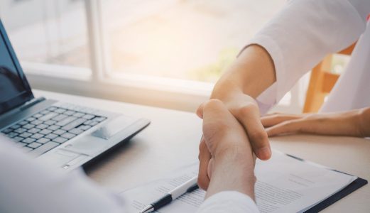 business people handshake with laptop computer and clipboard on desk after finishing up a business meeting contract in office, successful, meeting, partnership, teamwork, community, connection concept