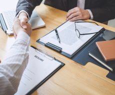 Greeting new colleagues, Handshake while job interviewing, male candidate shaking hands with Interviewer or employer after a job interview, employment and recruitment concept.