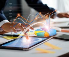 Businessman using tablet and laptop analyzing sales data and economic growth graph chart. Business strategy. Digital marketing. Business innovation technology concept